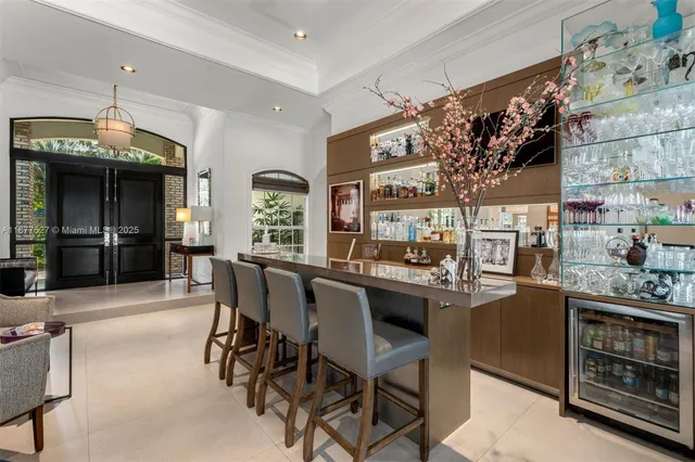 a kitchen with stainless steel appliances kitchen island granite countertop a table and chairs in it