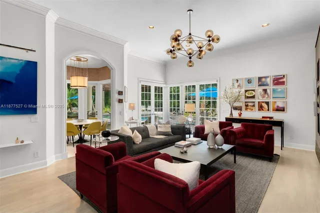 a living room with furniture or chandelier and a window