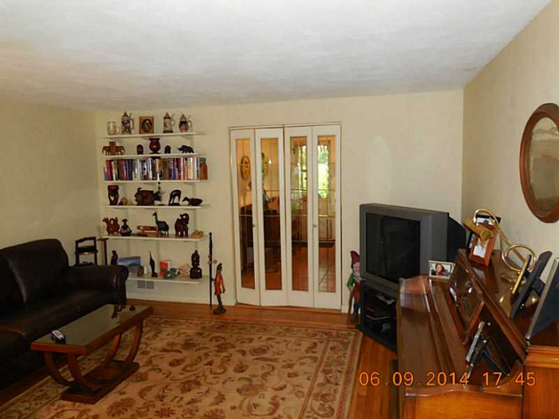 31 Baldwin Road Warwick, RI 02886 - Photo 8 of 25 Living Room. View of the living room from the front door. Glass doors separate the living room from the large dining area and kitchen.