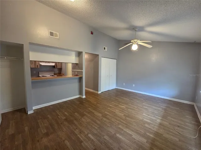 a view of a kitchen with a sink and a refrigerator
