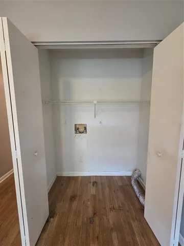 a view of walk in closet with wooden floor