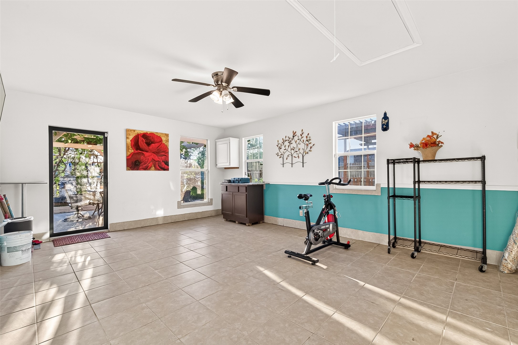 16715 Mackenzie Mesa Drive Spring, TX 77379 - Photo 20 of 50 a living room with furniture and a gym machine