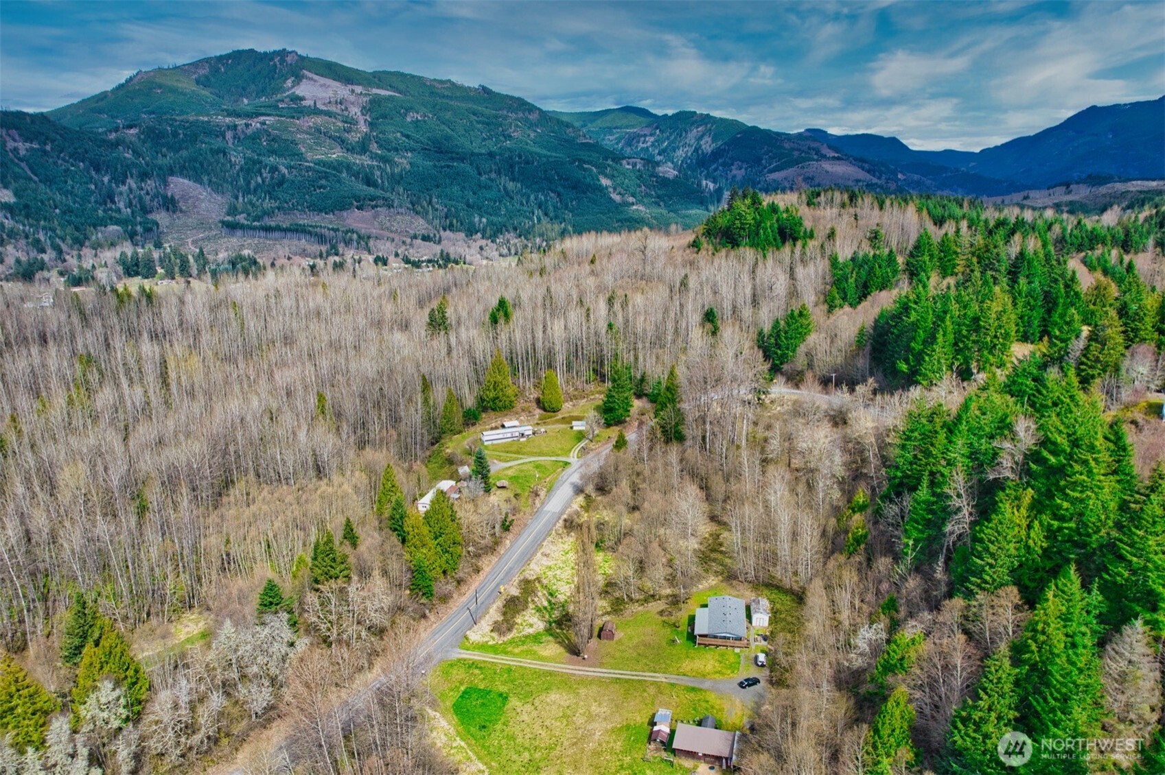 404 Meade Hill Road Glenoma, WA 98336 - Photo 7 of 40 a view of a lush green hillside and a building