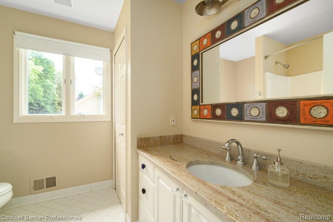 4147 Calumet Drive Rochester, MI 48306 - Photo 26 of 35 Upstairs main bathroom with granite tops and new fixtures