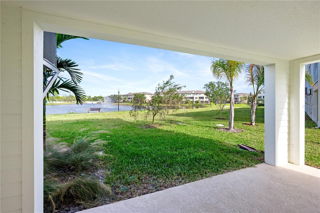9973 Key Haven Road Seminole, FL 33777 - Photo 13 of 59 a view of a big yard with potted plants and palm trees