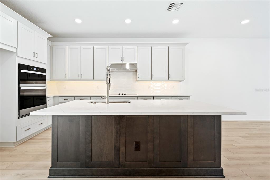 9973 Key Haven Road Seminole, FL 33777 - Photo 19 of 59 a kitchen with a sink cabinets and stainless steel appliances