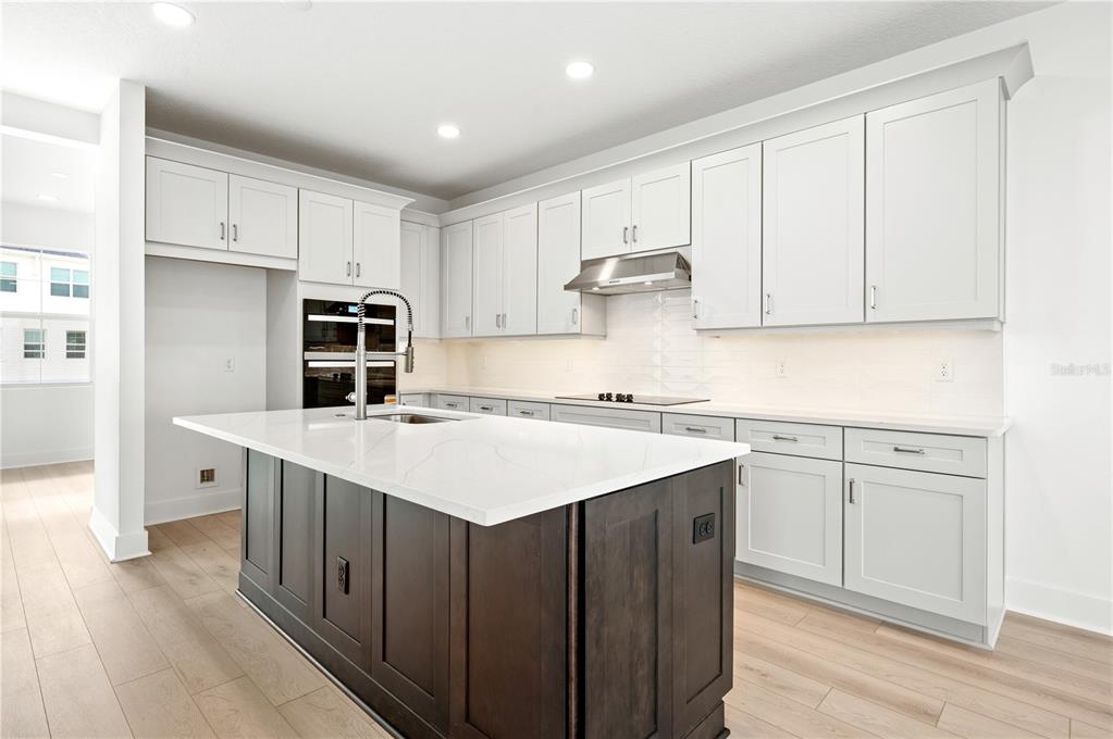 9973 Key Haven Road Seminole, FL 33777 - Photo 20 of 59 a kitchen with kitchen island sink stove and cabinets