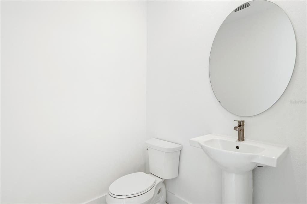 9973 Key Haven Road Seminole, FL 33777 - Photo 26 of 59 a bathroom with a sink a toilet and a mirror