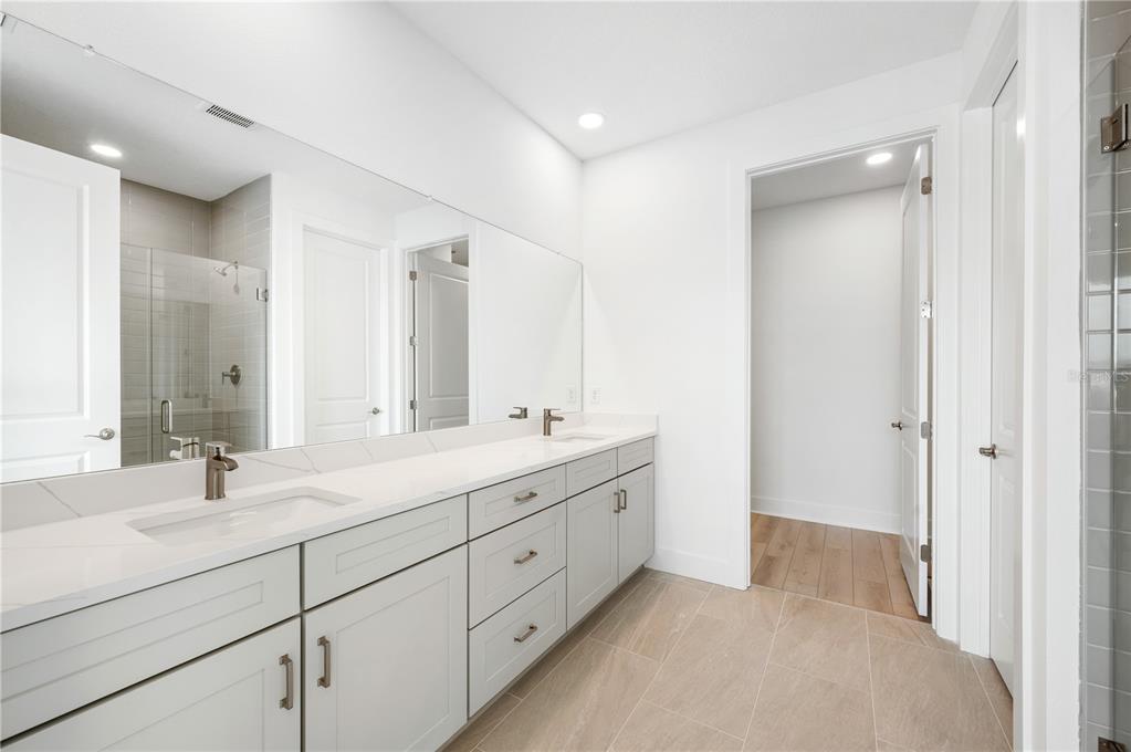 9973 Key Haven Road Seminole, FL 33777 - Photo 34 of 59 a bathroom with a double vanity sink mirror and