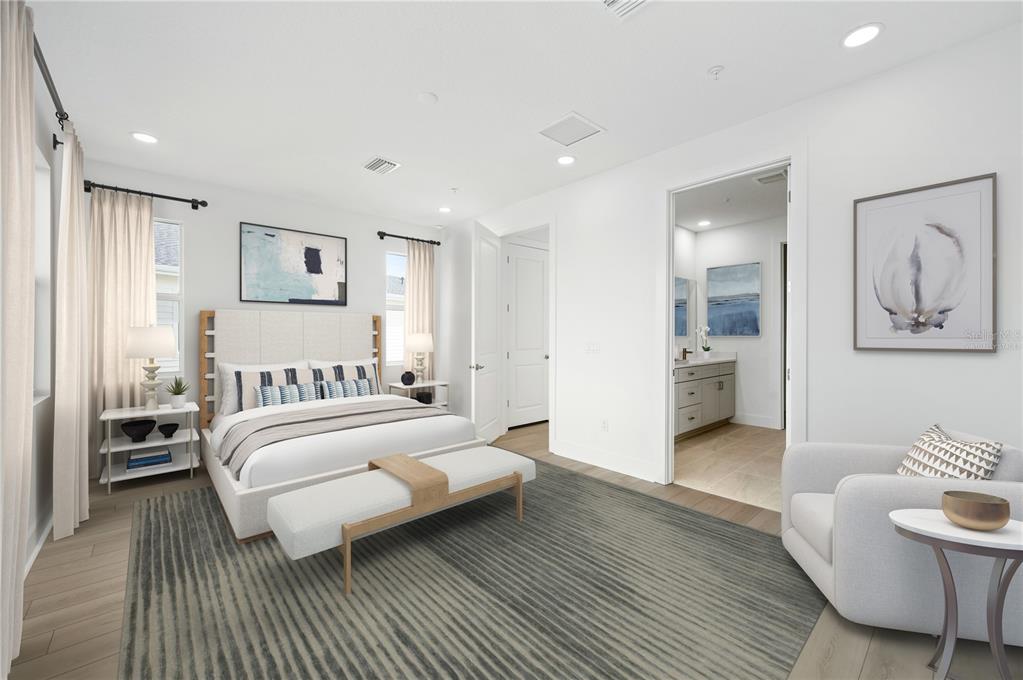 9973 Key Haven Road Seminole, FL 33777 - Photo 9 of 59 a spacious bedroom with a bed and a couch