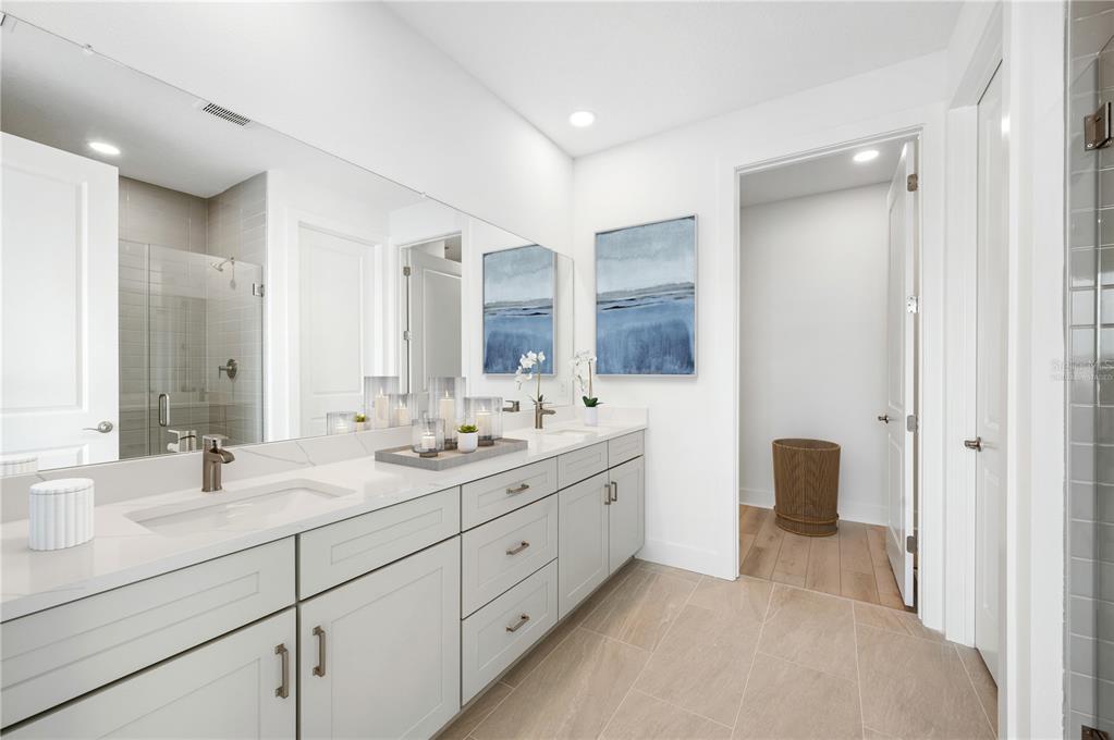 9973 Key Haven Road Seminole, FL 33777 - Photo 10 of 59 a bathroom with a double vanity sink and mirror with shower