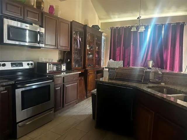 a kitchen with a sink stove and microwave