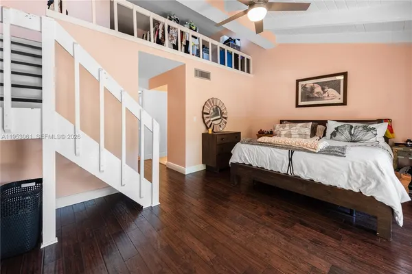 a spacious bedroom with a bed and a large window