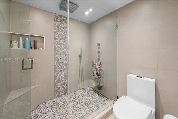 a bathroom with a toilet and a shower
