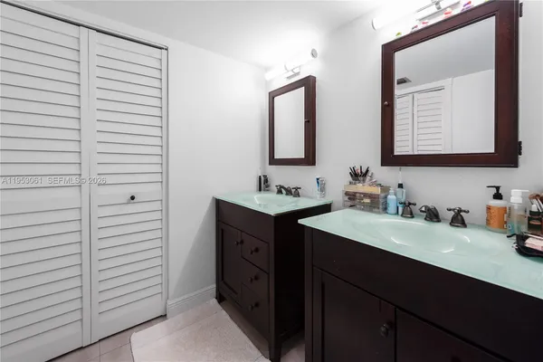 a bathroom with a double vanity sink and a mirror