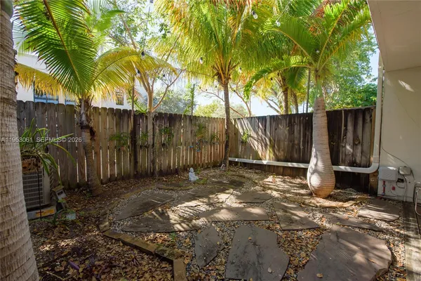 a backyard of a house with table and chairs