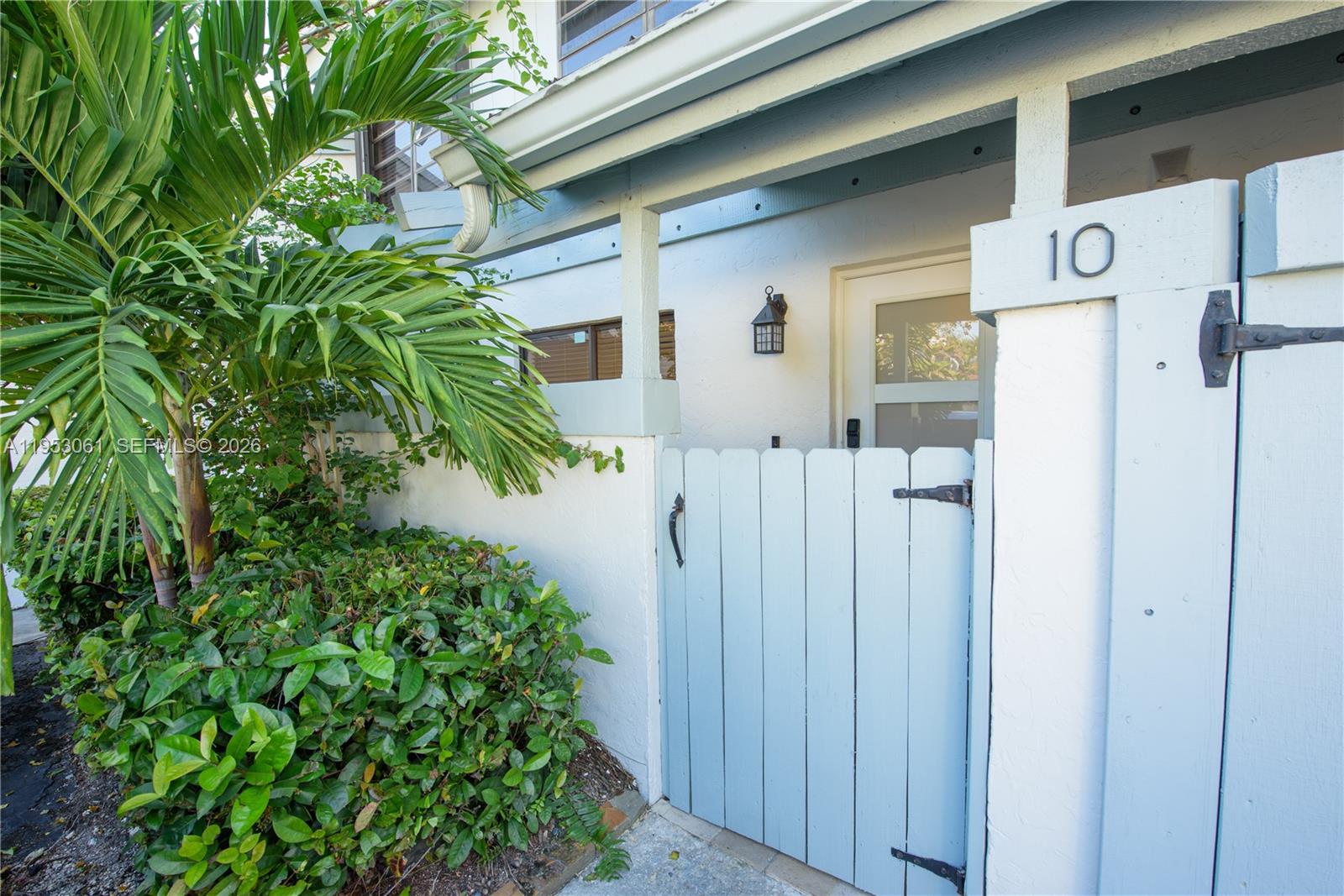 7890 Southwest 86th Street, Unit 10 Miami, FL 33156 - Photo 23 of 32 a view of a house with a flower plants