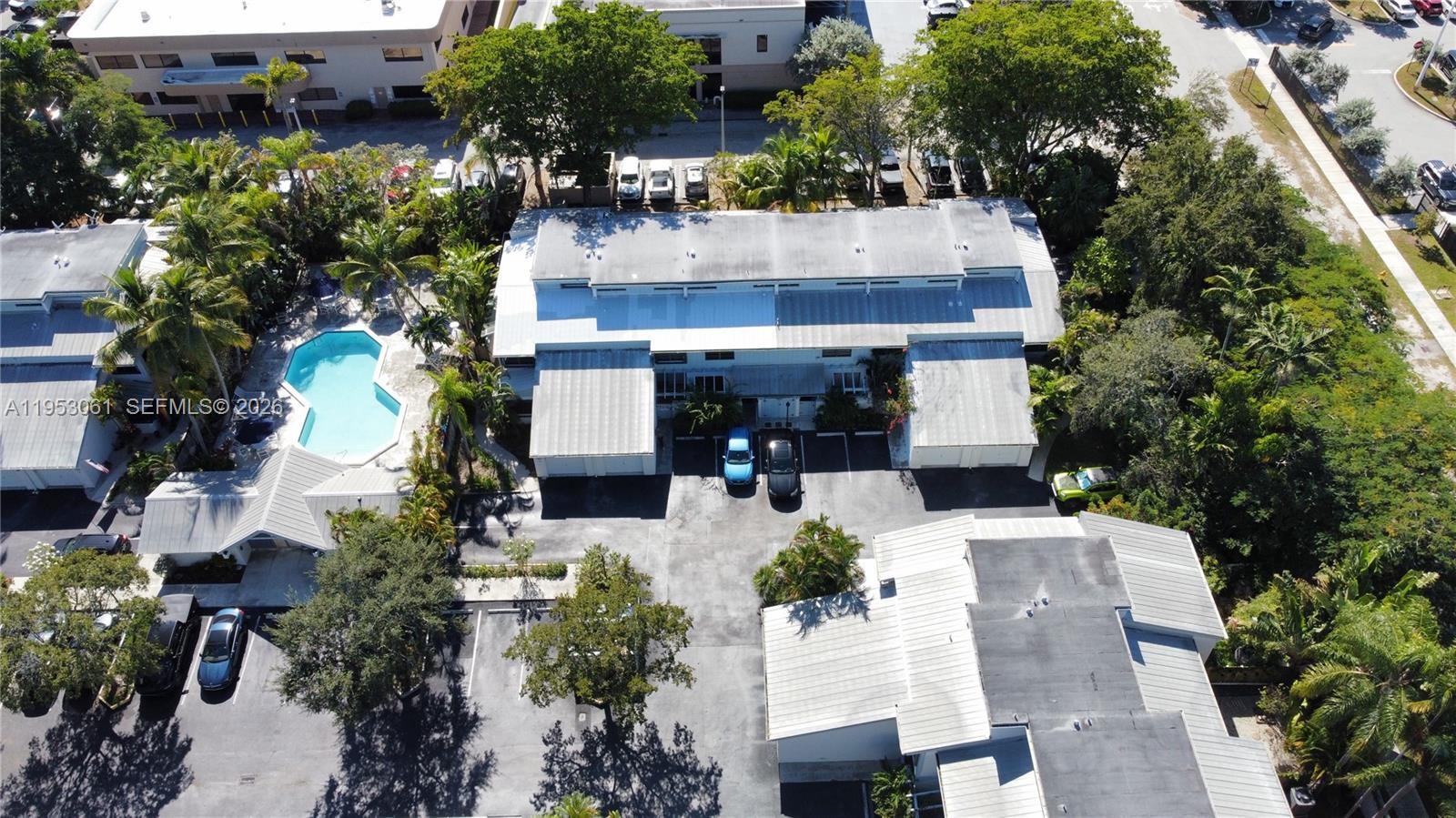 7890 Southwest 86th Street, Unit 10 Miami, FL 33156 - Photo 30 of 32 an aerial view of a house with a yard and tree s