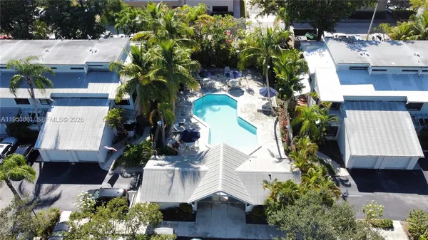 an aerial view of a house with a yard and garden