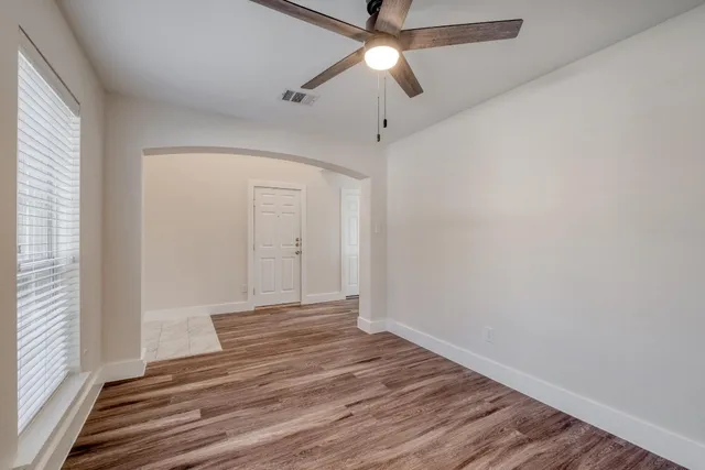 wooden floor in an empty room with a window