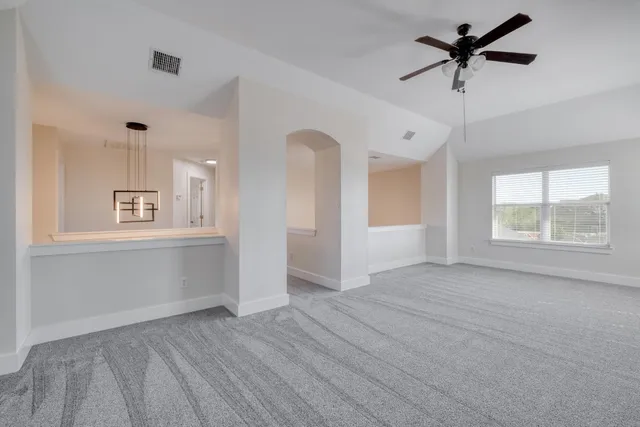 an empty room with windows and closet