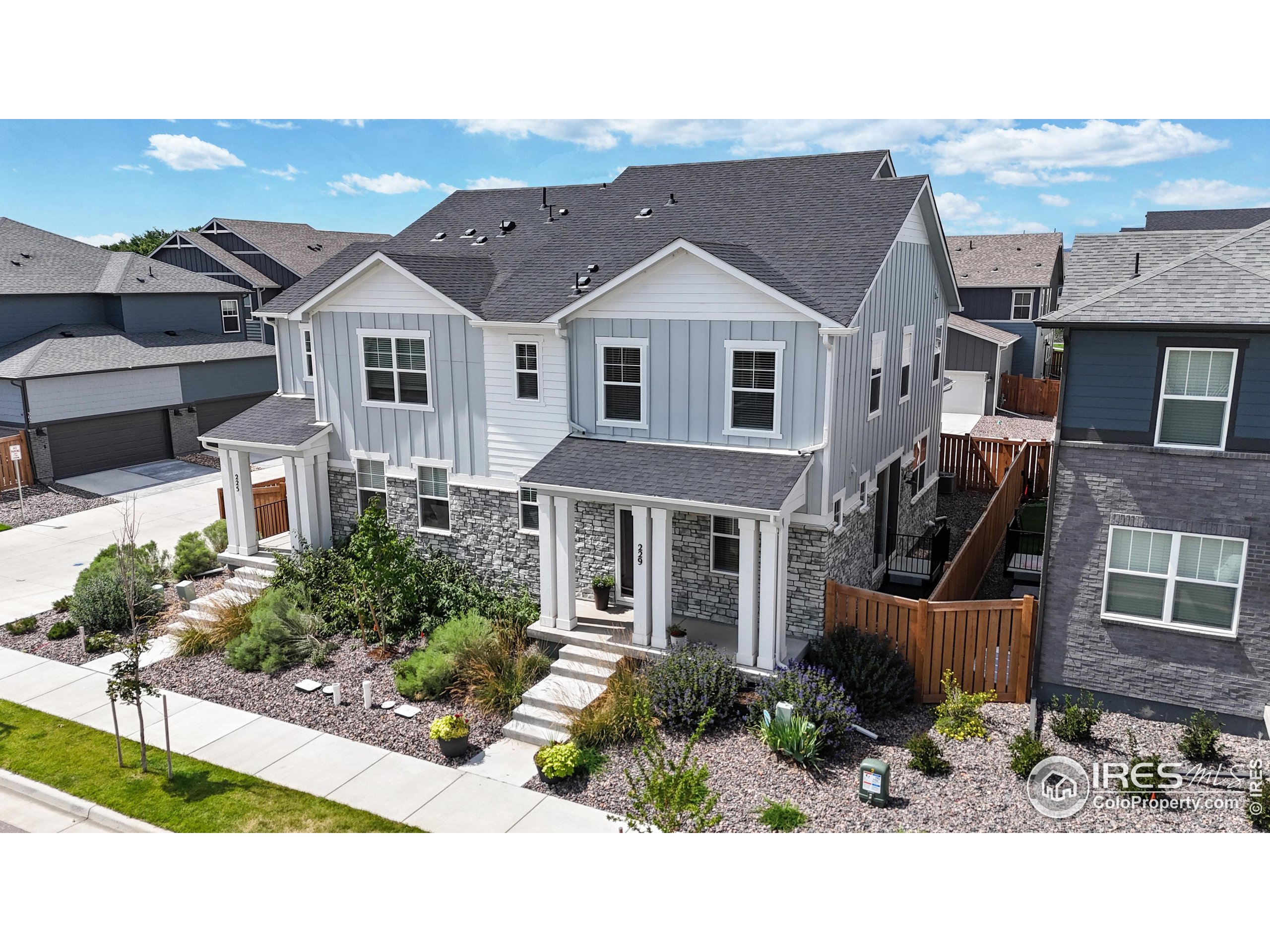 a view of a white house next to a yard