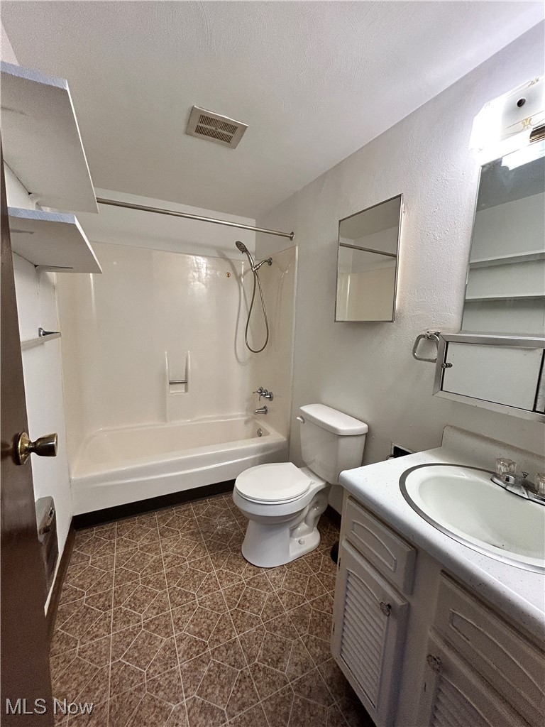 98 View Street, Unit 2 Weirton, WV 26062 - Photo 5 of 10 Bathroom featuring vanity, shower / tub combination, a textured ceiling, and a textured wall