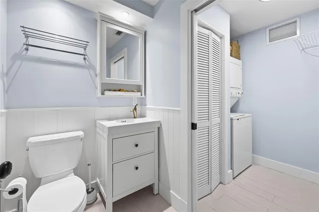 a bathroom with a toilet a sink and a mirror