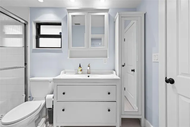 a bathroom with a sink a toilet and vanity