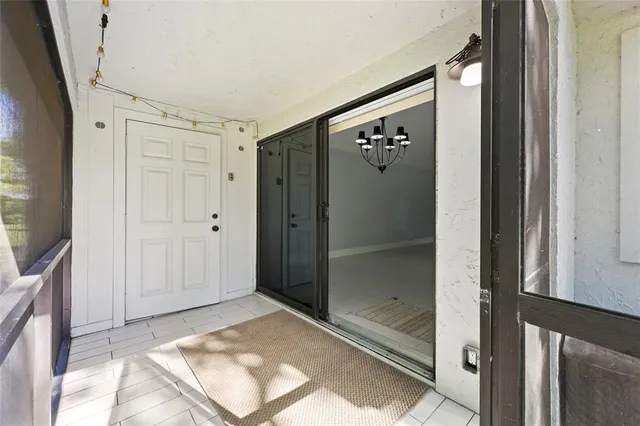 a view of a hallway with wooden floor and windows