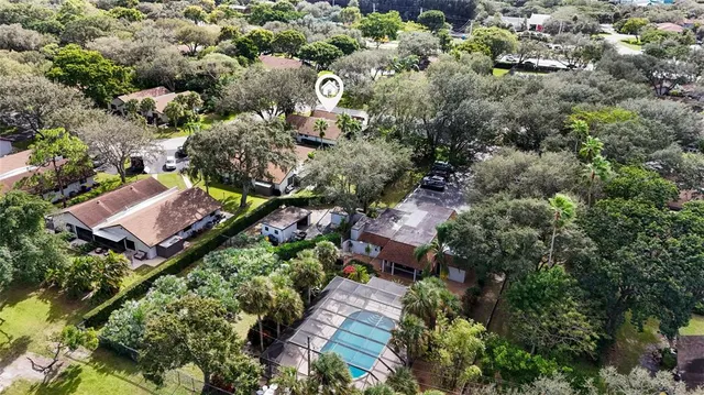 an aerial view of residential house with outdoor space and parking