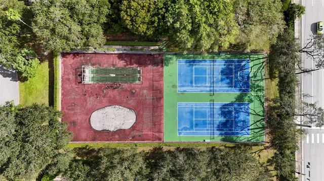 an aerial view of residential house with outdoor space and trees
