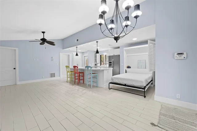 a view of a livingroom with furniture and a chandelier fan