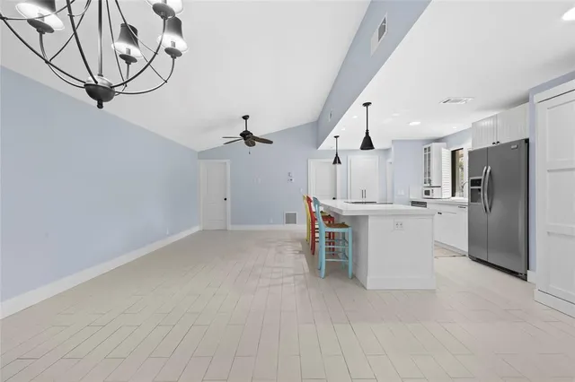 a view of kitchen with furniture and refrigerator
