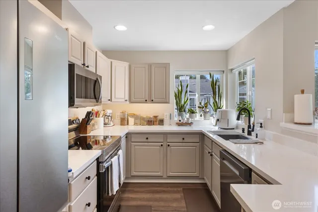 a kitchen with a sink stove and cabinets