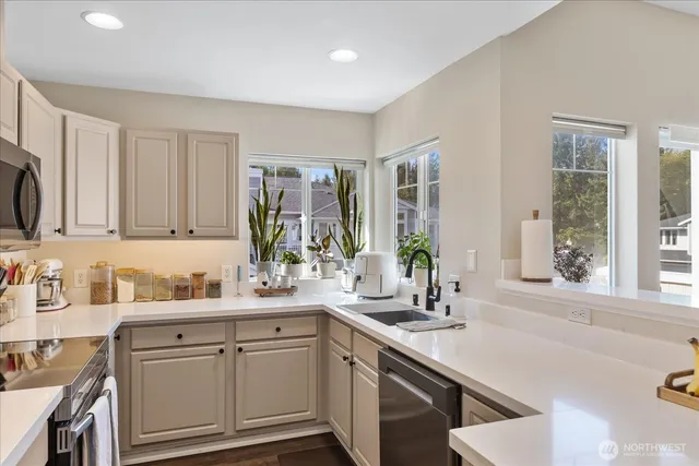 a kitchen with a sink stove and cabinets