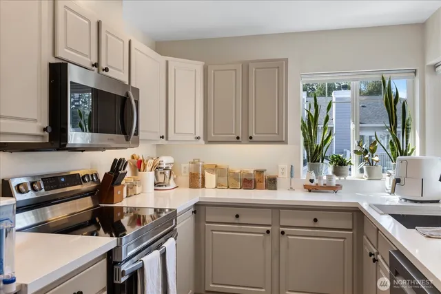 a kitchen with stainless steel appliances a sink stove and cabinets