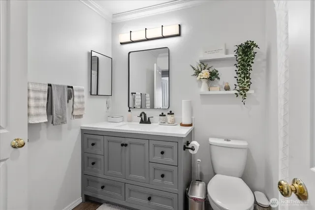 a bathroom with a toilet sink and mirror