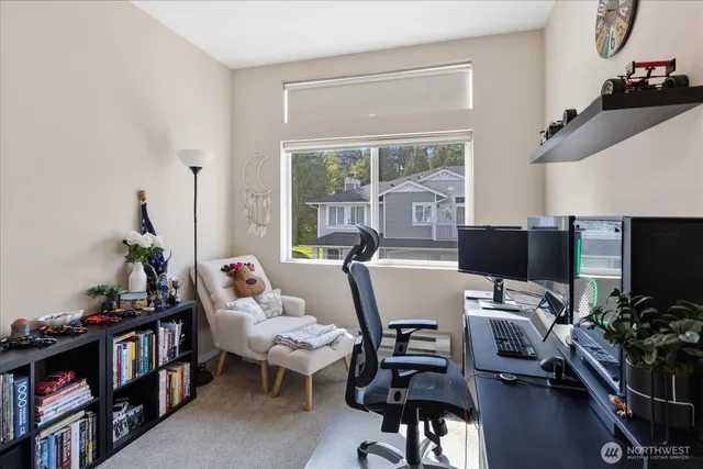 a living room with furniture a flat screen tv and a bookshelf