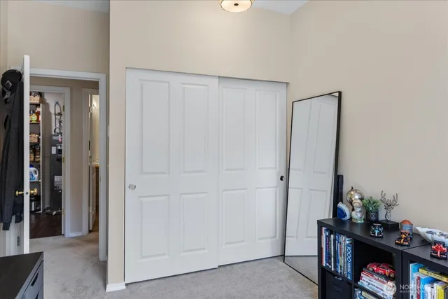 a view of a livingroom with closet and toys