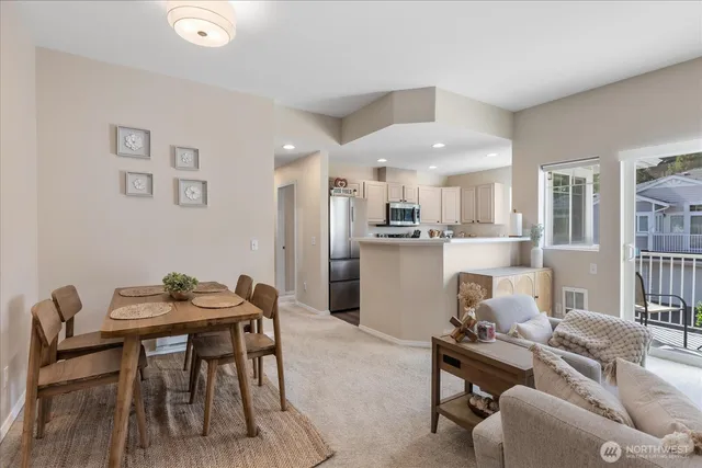 a living room with furniture and kitchen view
