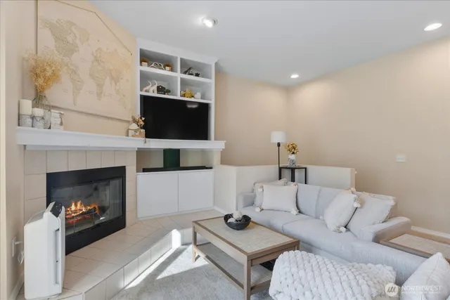 a living room with furniture a flat screen tv and a fireplace