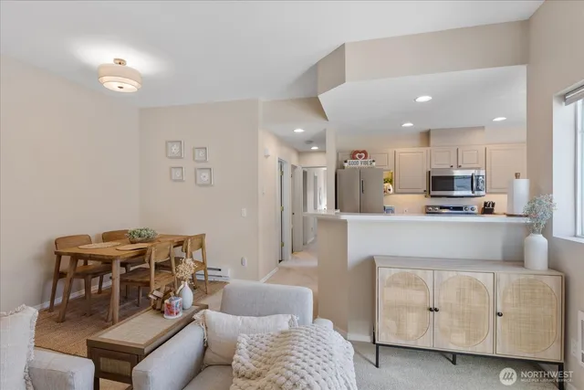 a living room with furniture and kitchen view