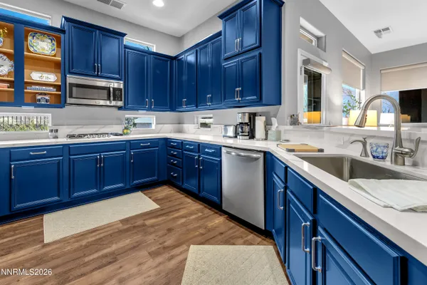 a kitchen with stainless steel appliances granite countertop wooden cabinets a sink and dishwasher