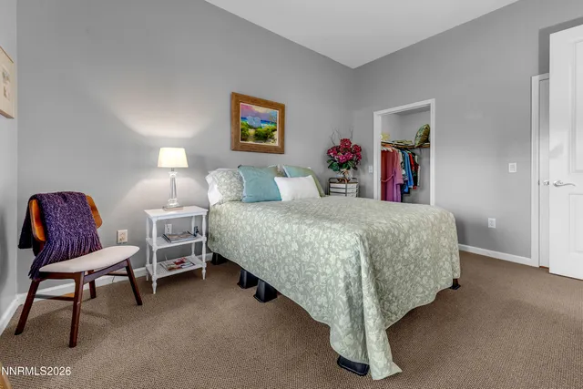 a bedroom with a bed and windows