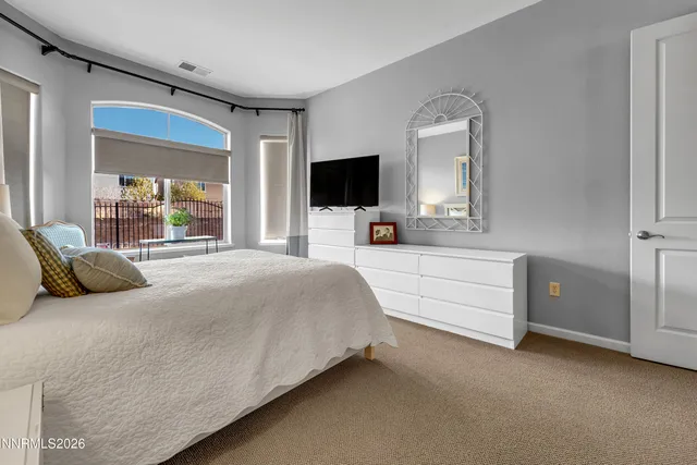 a view of a balcony with table and chairs and wooden fence