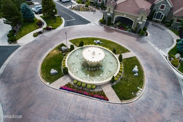 a living room with furniture a large window and a fireplace