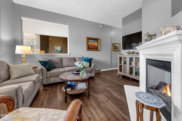 a kitchen with stainless steel appliances a dining table chairs and wooden floor