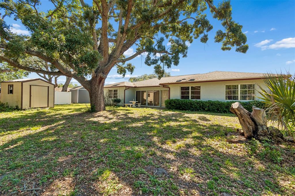 2059 Waterfall Drive Spring Hill, FL 34608 - Photo 22 of 26 a front view of a house with a garden
