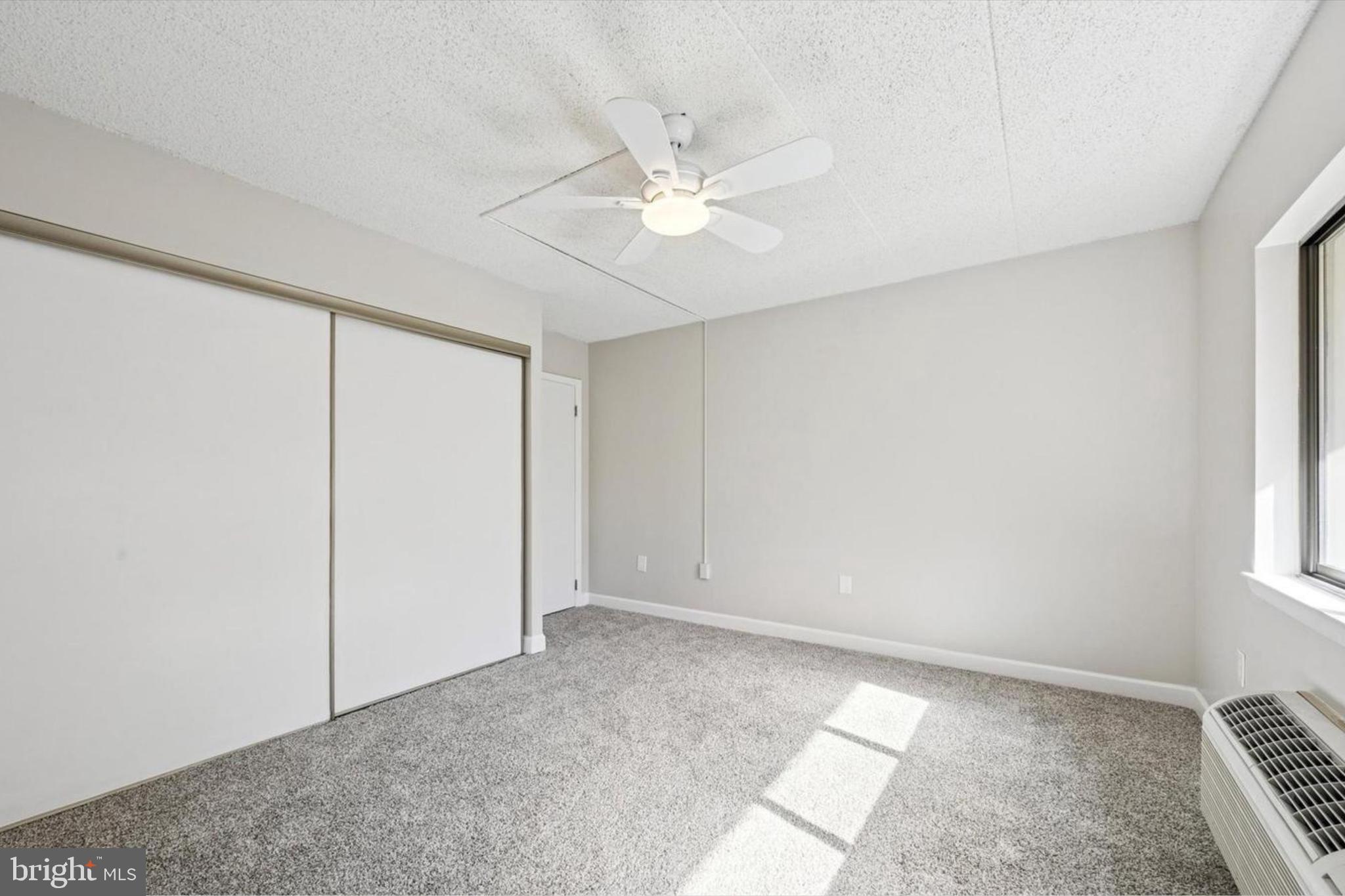 800 Avondale Road, Unit 7B Wallingford, PA 19086 - Photo 12 of 24 an empty room with windows and fan